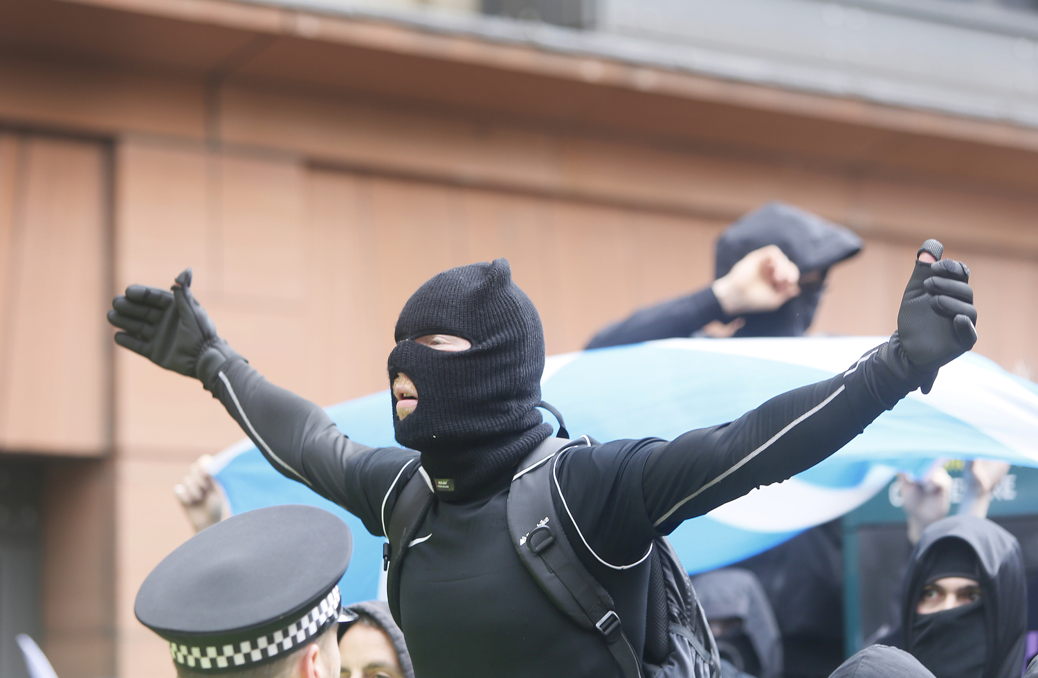 Masked anti-migrant protestors dressed in black gathered in Glasgow city centre on 13 June. Photo by Angela Catlin Masked anti-migrant protestors dressed in black gathered in Glasgow city centre on 13 June. Photo by Angela Catlin